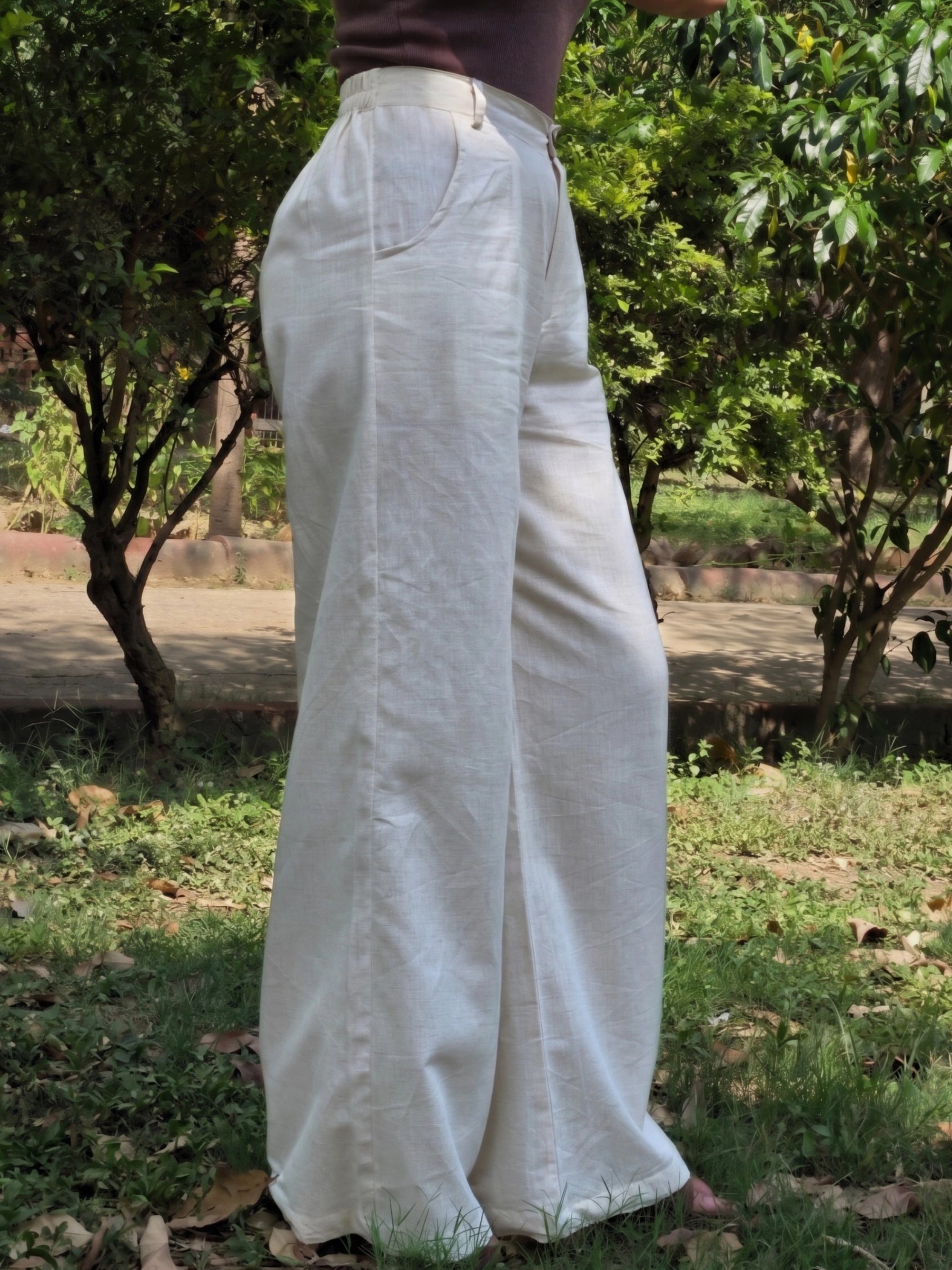 Full-length view of loose fitted beige long pants made from premium cotton linen flax blend.
