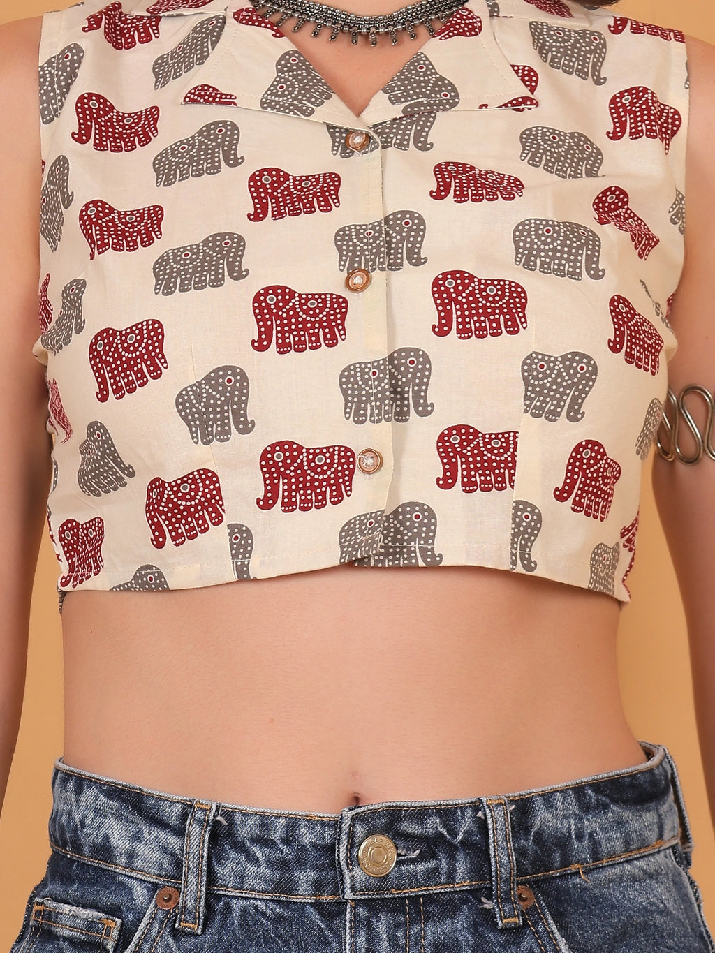 Detailed close-up of the breathable rayon fabric, highlighting the crisp button closure and vibrant red traditional motifs on the white ethnic crop shirt.