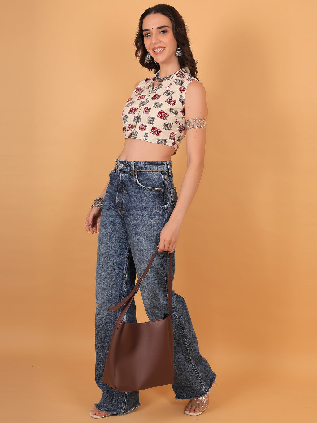 College outfit idea: White quirky print crop top styled with silver arm cuff.