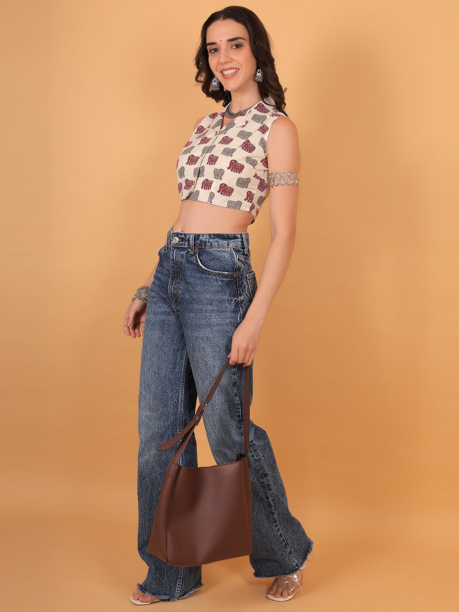 College outfit idea: White quirky print crop top styled with silver arm cuff.