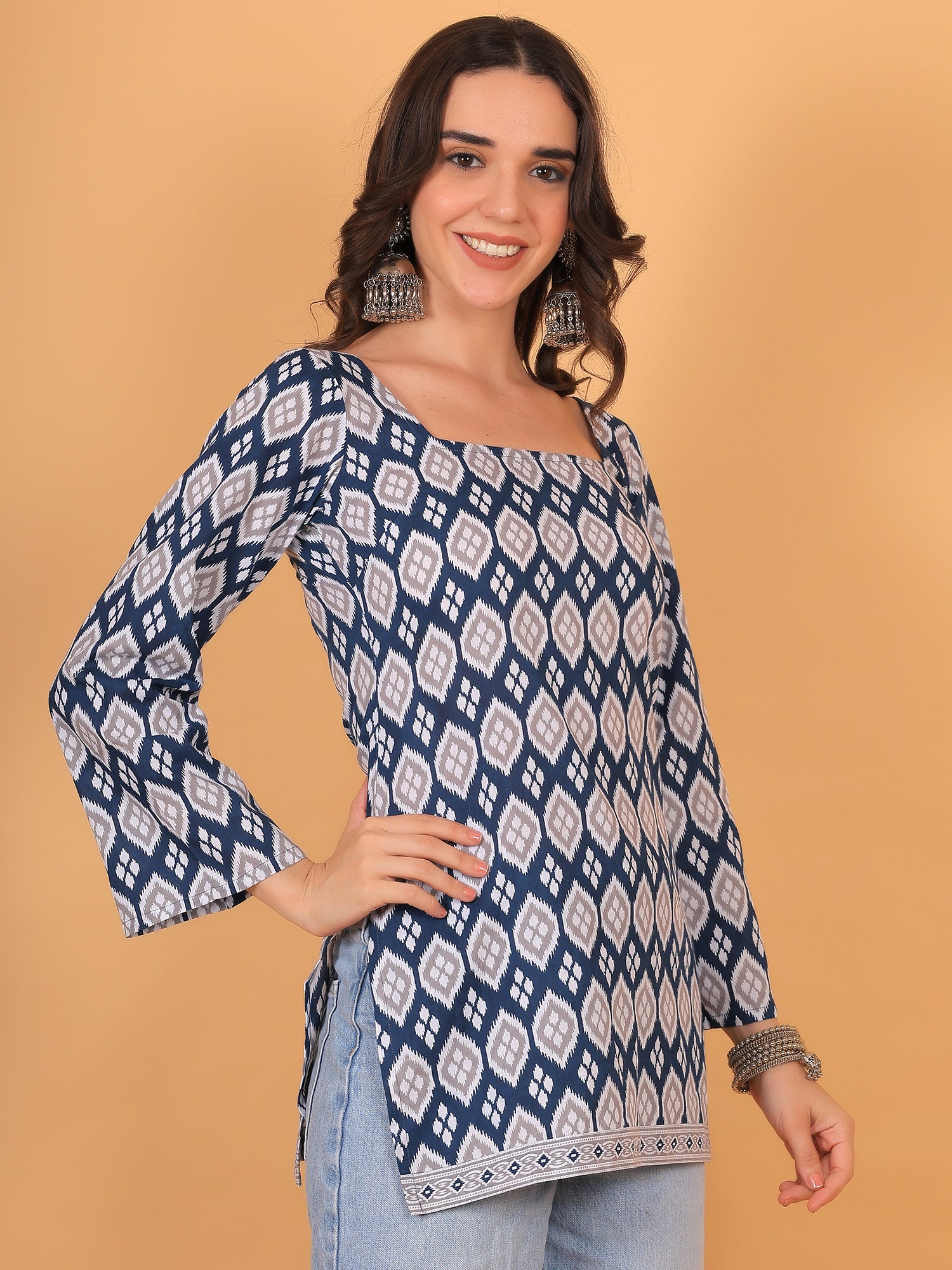Trendy Indo-western tunic top for women with long flared sleeves.