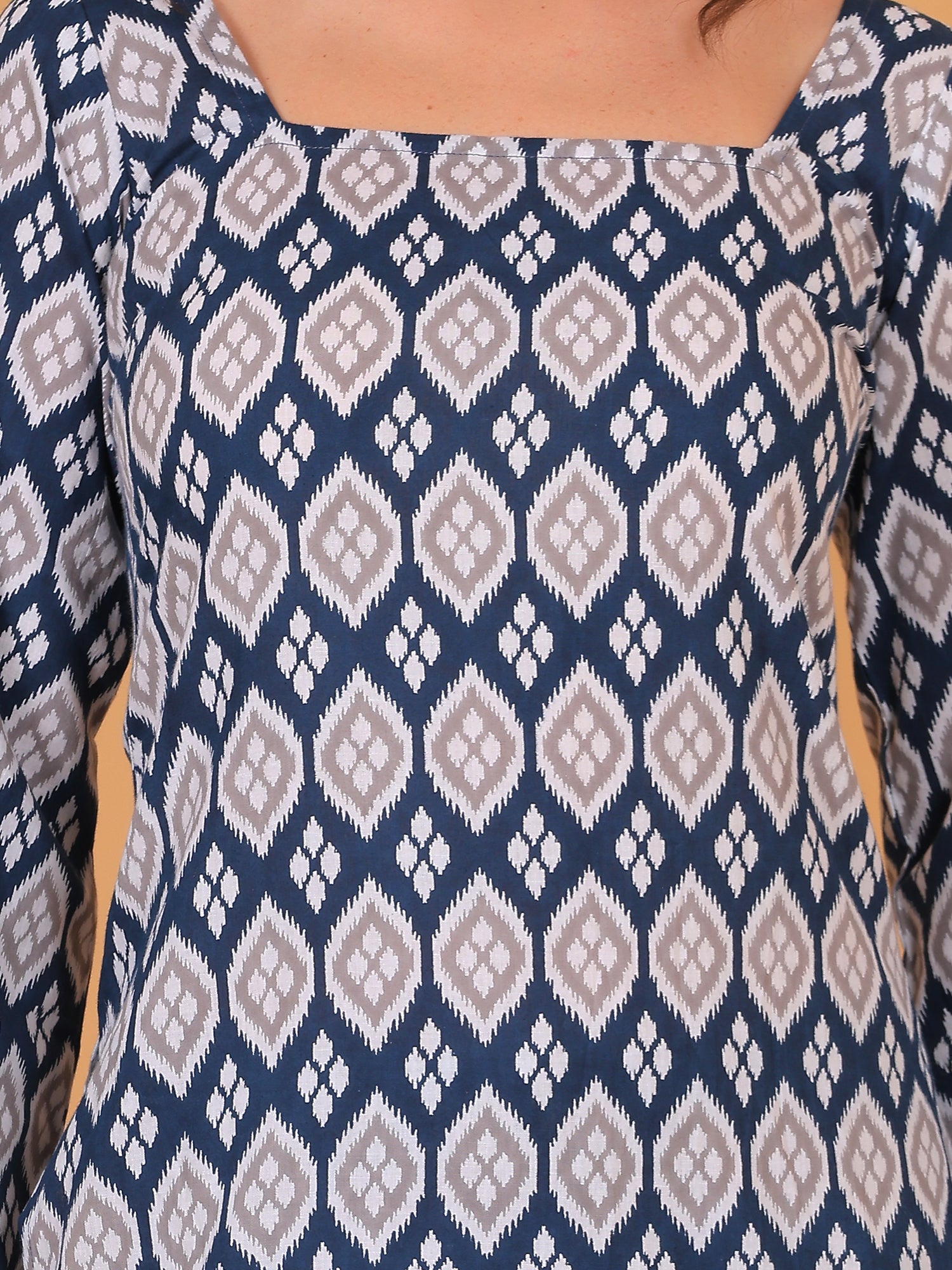 Close up of blue cotton fabric with geometric Ikat pattern print