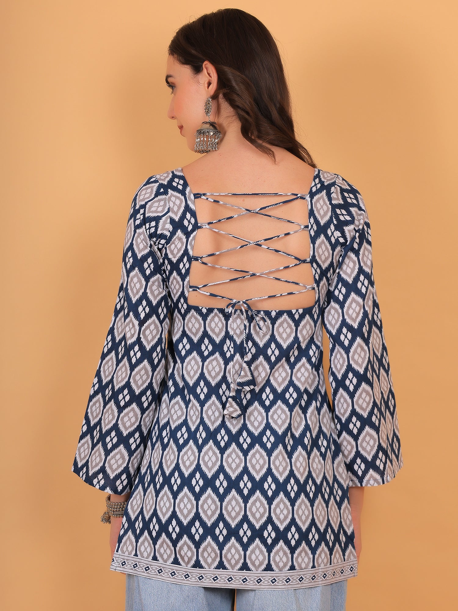 Stylish backless kurti design with criss-cross dori tie-up and corset style back.