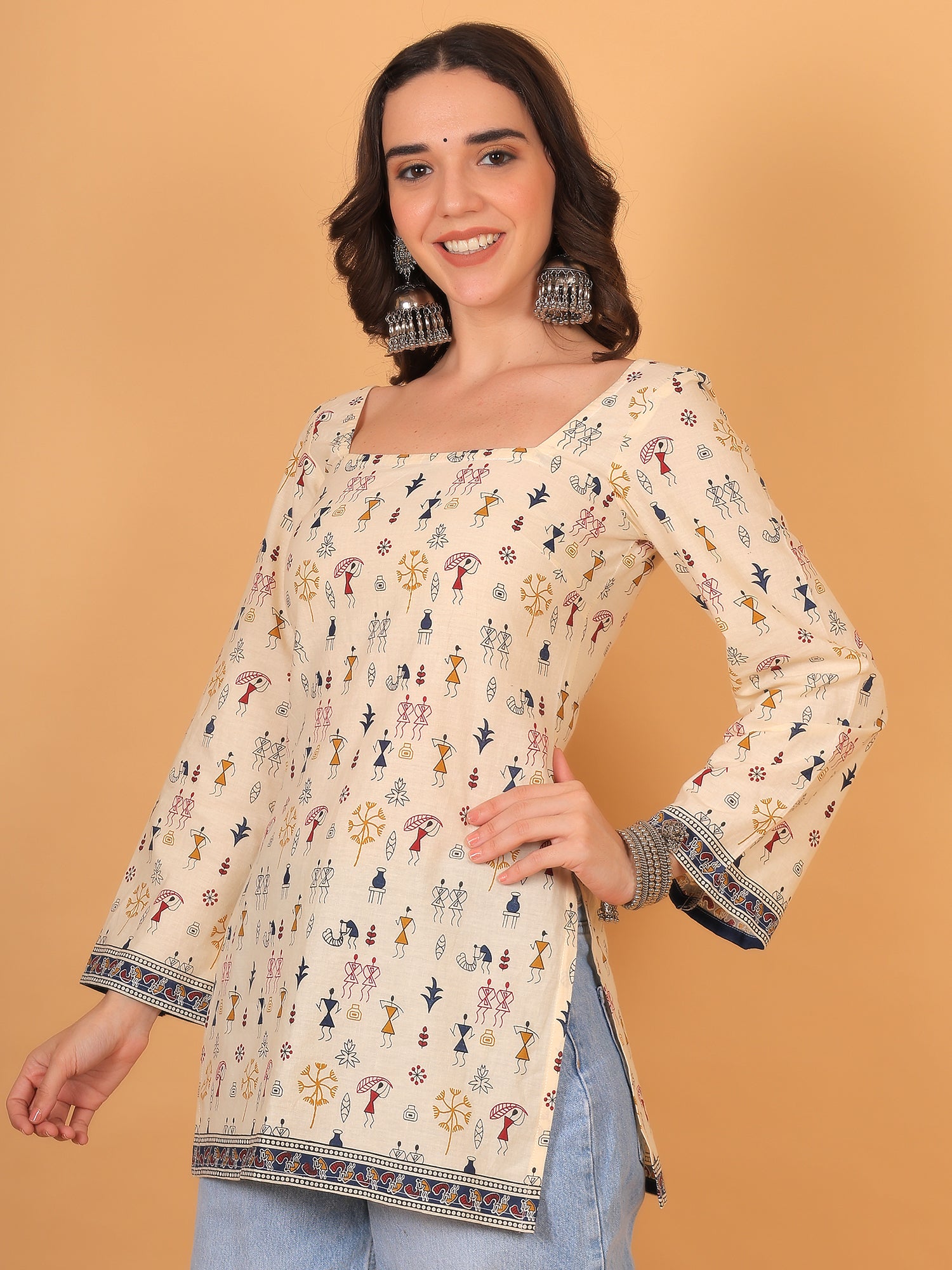 Indo-western cream tunic paired with light wash denim jeans.