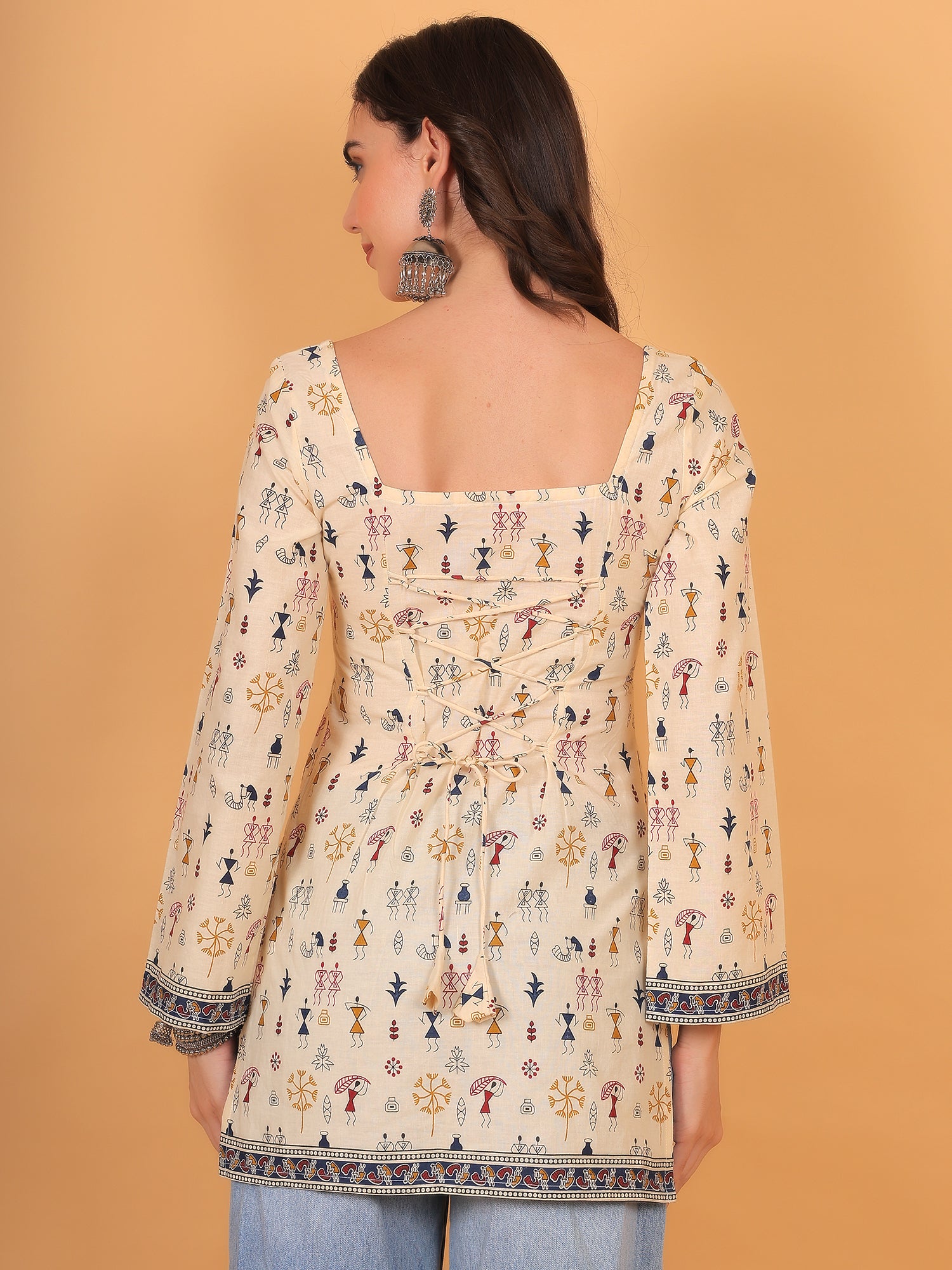 Back view of beige corset style kurti with dori tie-up detail.