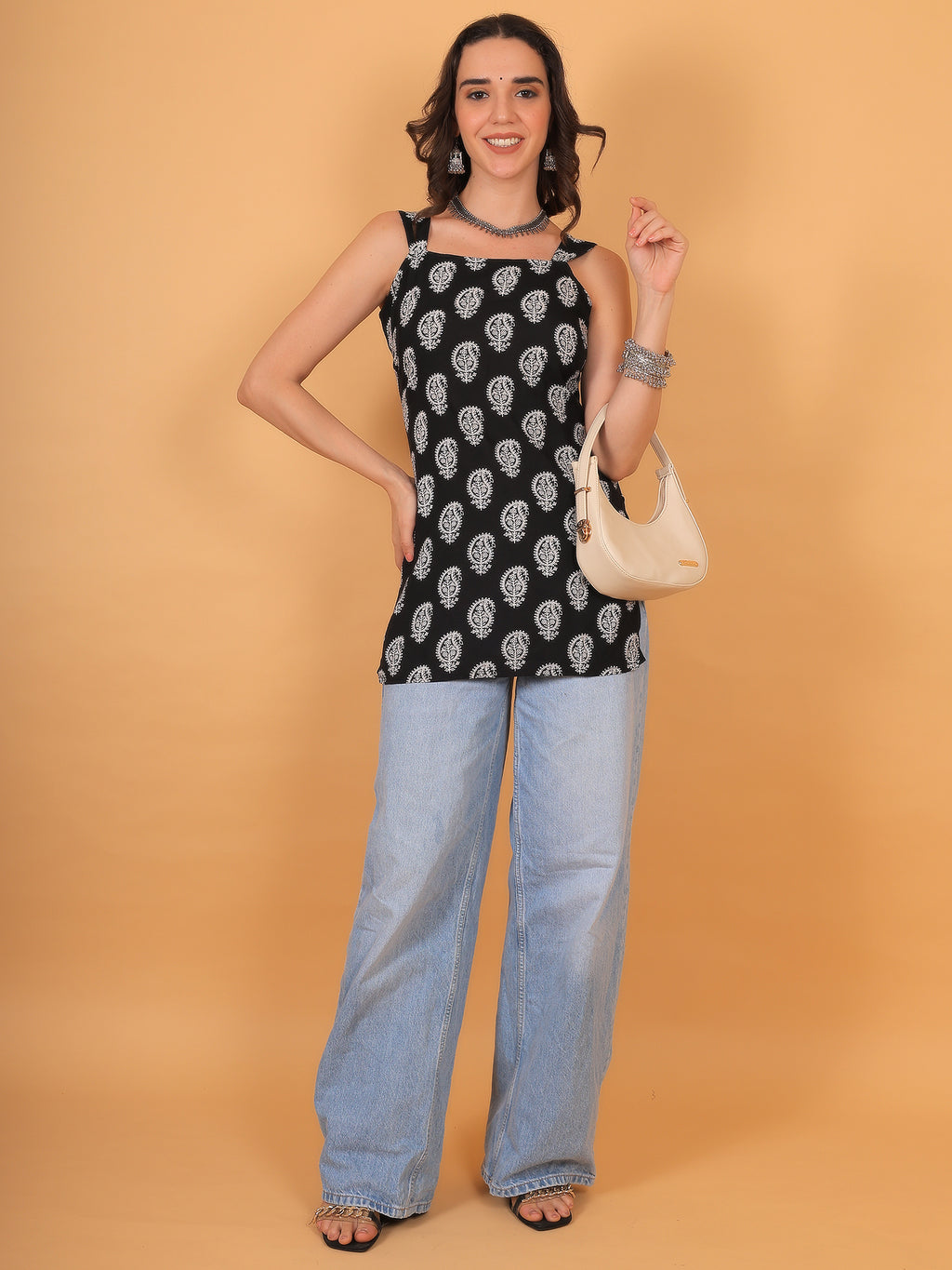 Trendy square neck black printed short kurti styled with light-wash wide-leg jeans for a boho look.