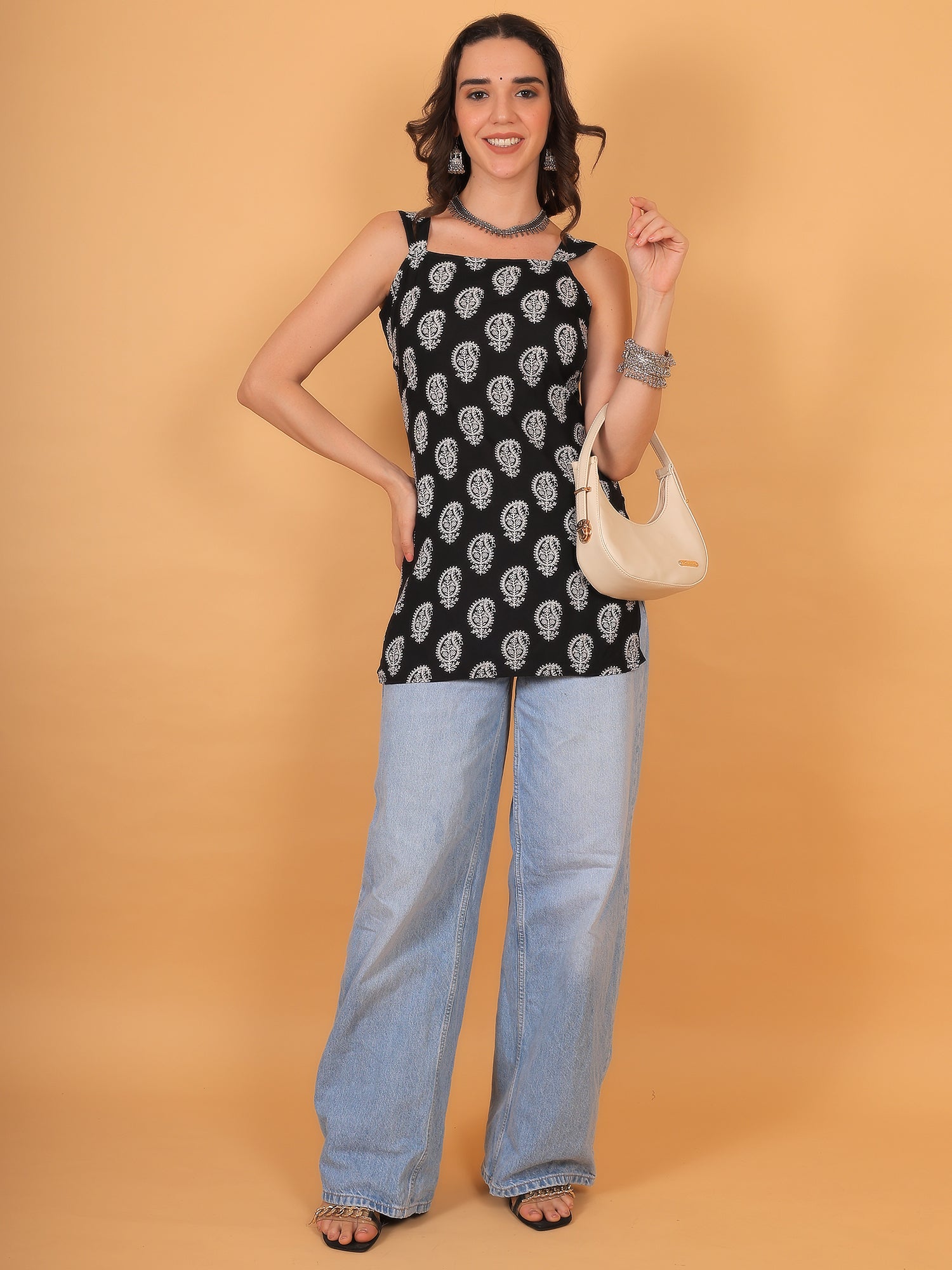 Trendy square neck black printed short kurti styled with light-wash wide-leg jeans for a boho look.