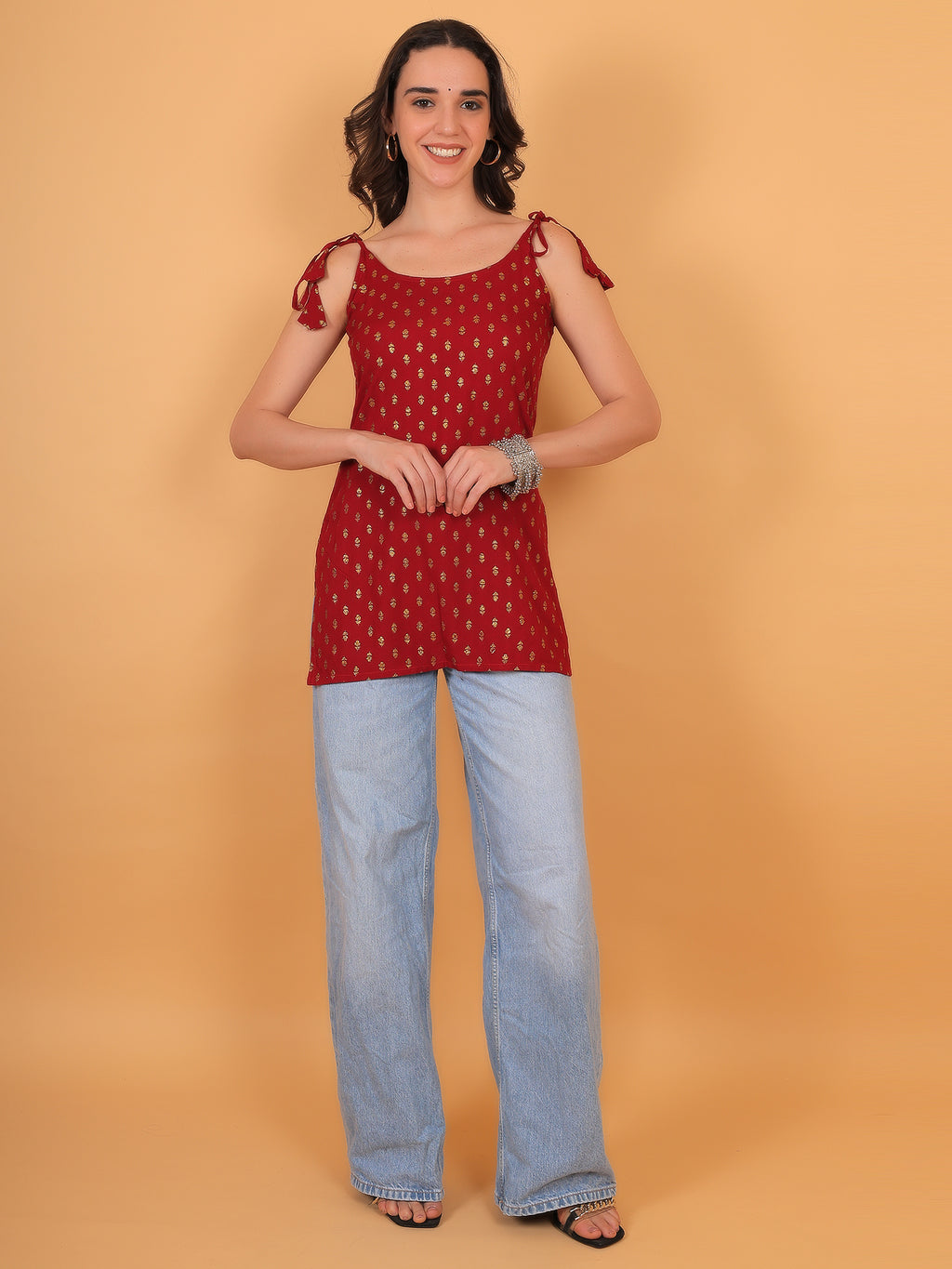 Festive red outfit idea for college girls featuring gold printed sleeveless top.
