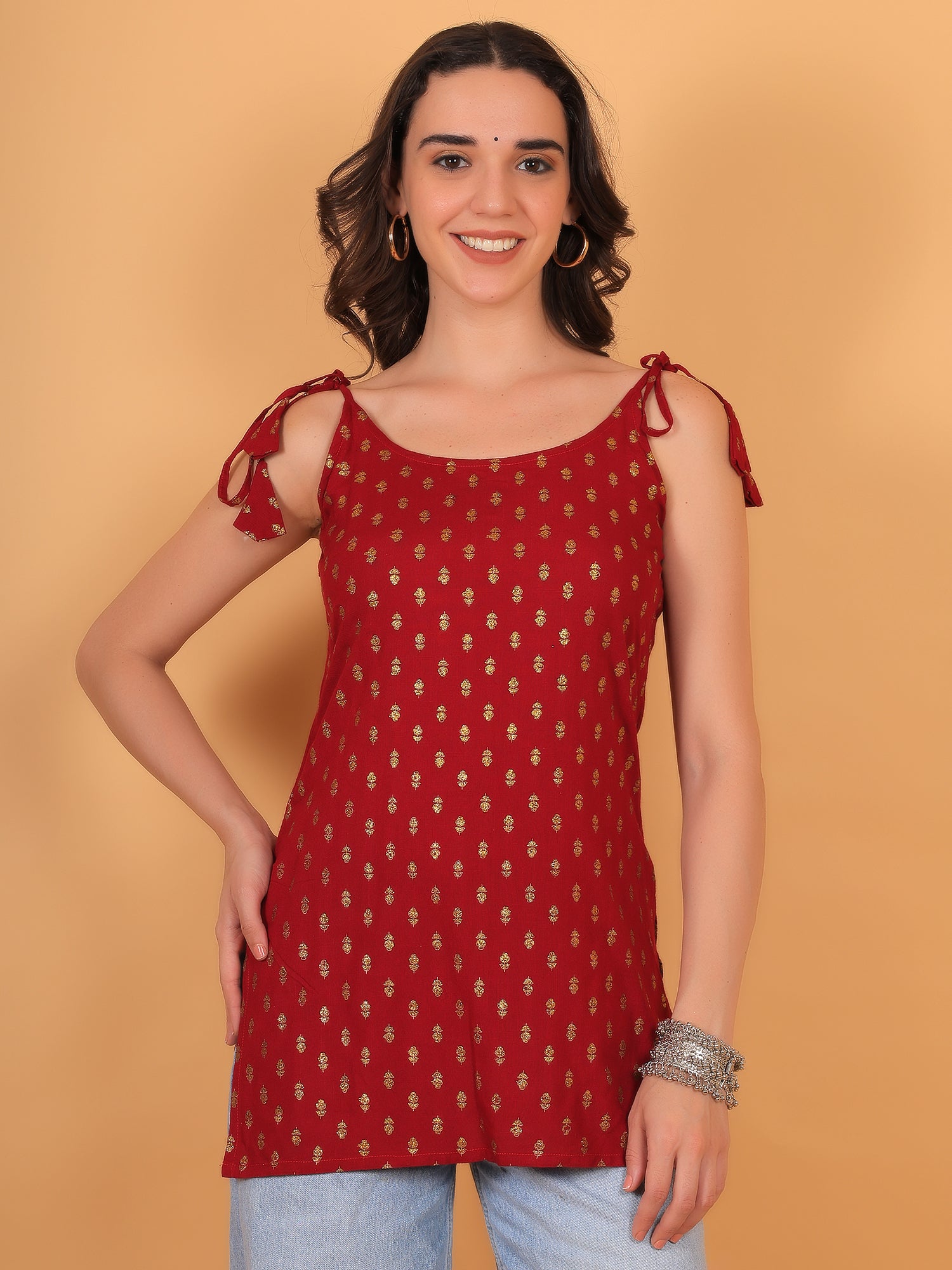 Bright red sleeveless kurti with golden ethnic motifs and adjustable knot-tie shoulders