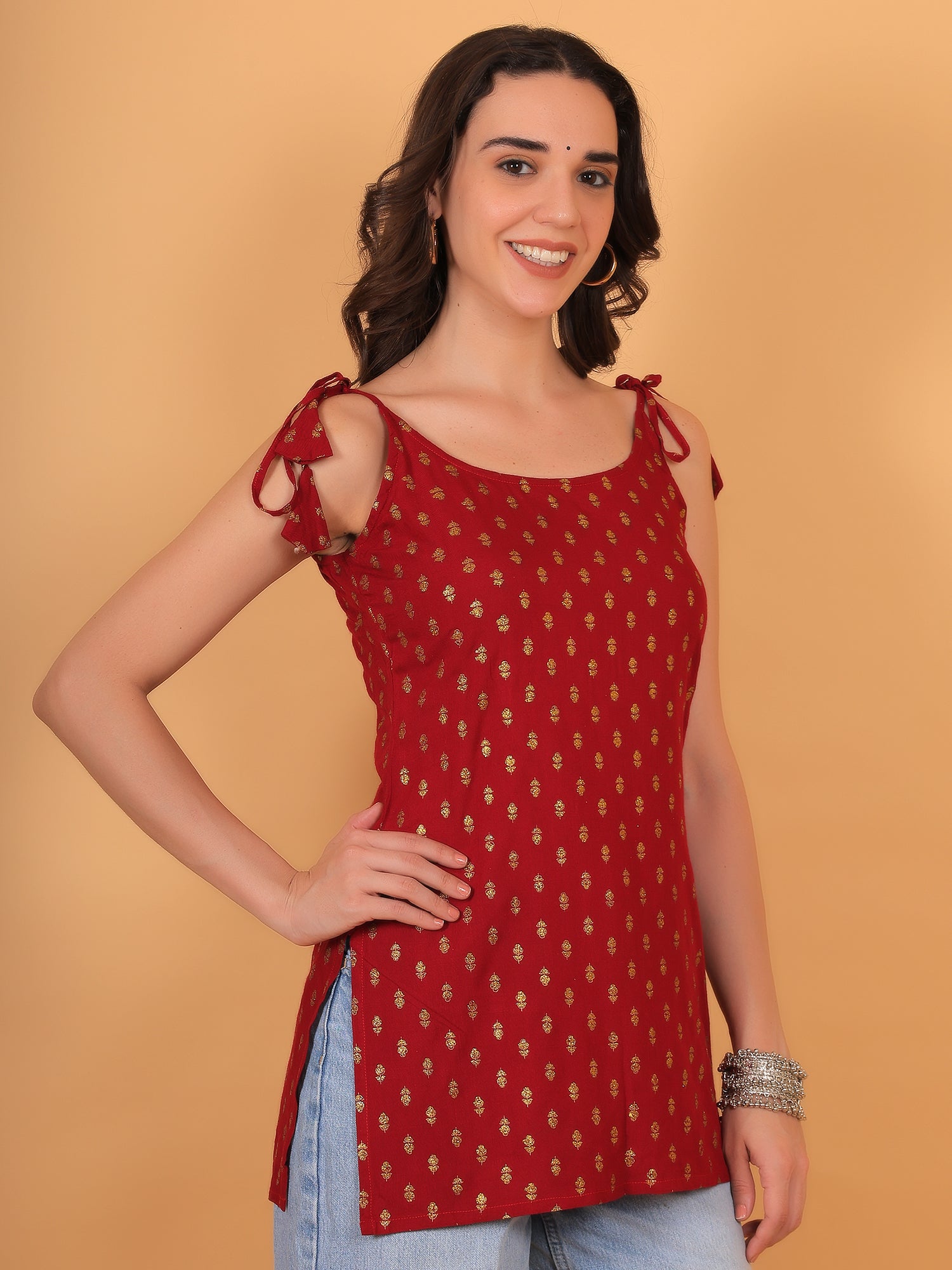 Trendy tie-up shoulder strap design on red sleeveless ethnic crop top.