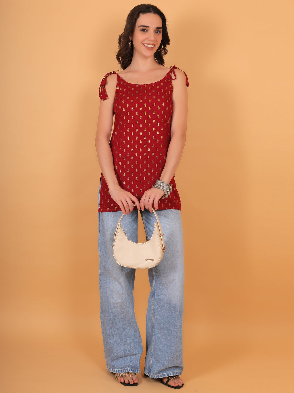 Woman wearing red Y2K style ethnic kurti paired with denim jeans for fusion look.
