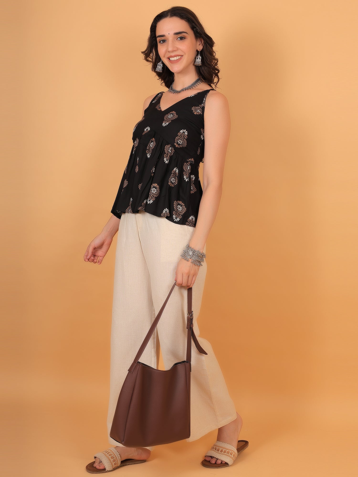 Black fit and flare top with beige pants