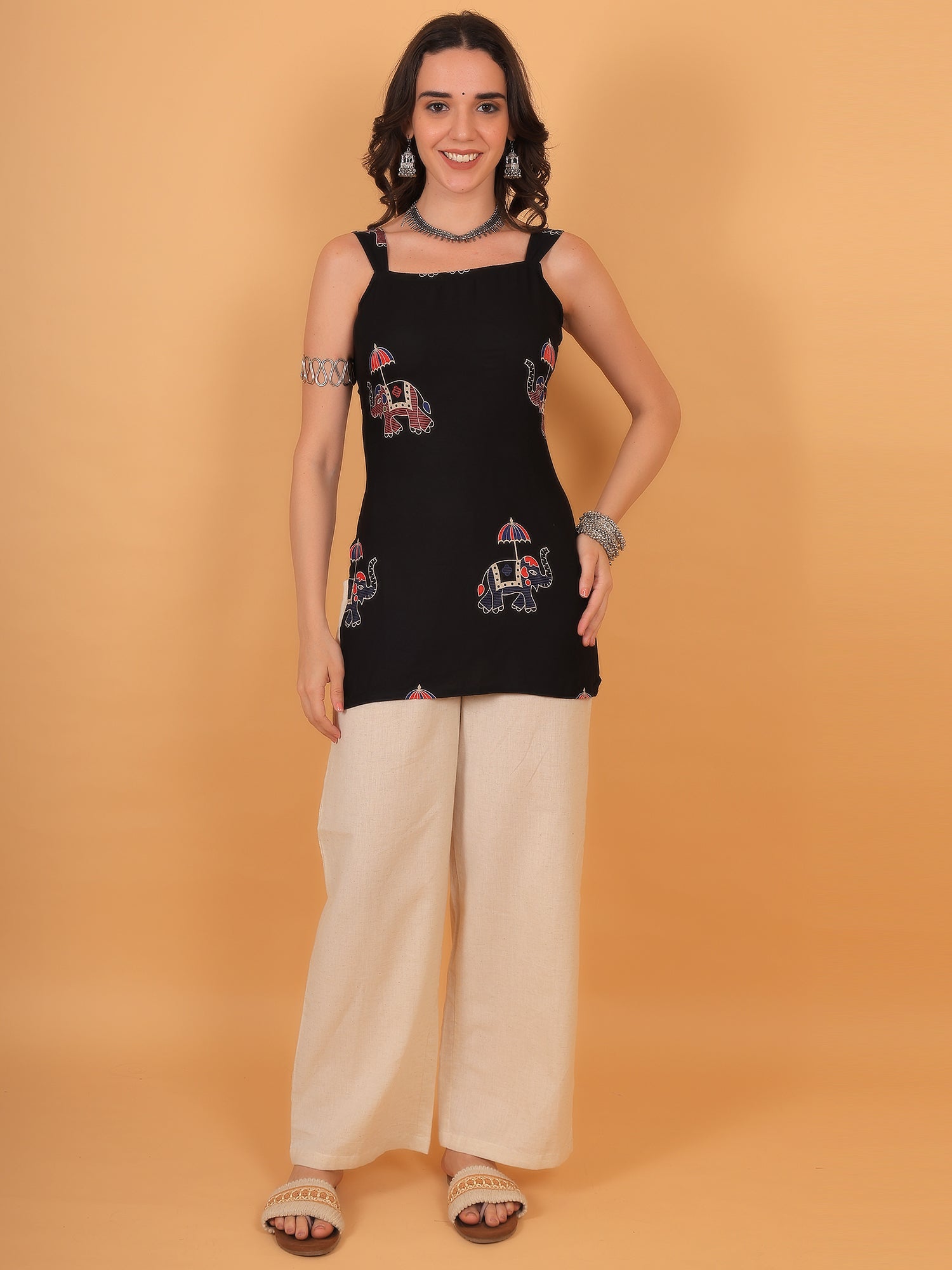 Boho chic outfit idea featuring black elephant print top and silver jewelry.