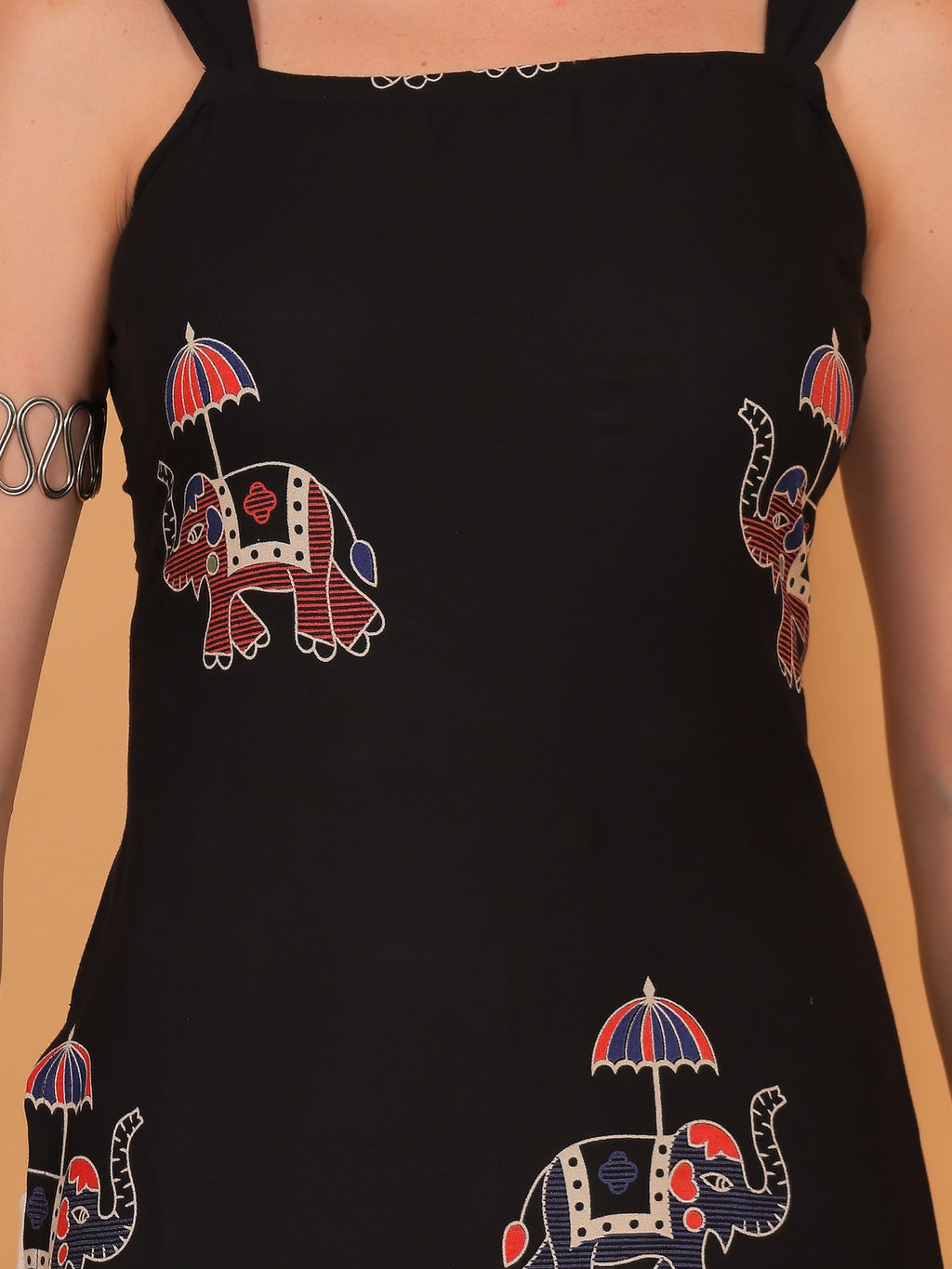 Traditional elephant and umbrella block print design on black fabric.