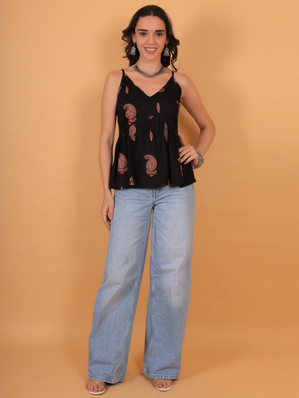 A stylish black and gold printed rayon short kurti for women, perfect for college styling, everyday outfits, or casual wear.