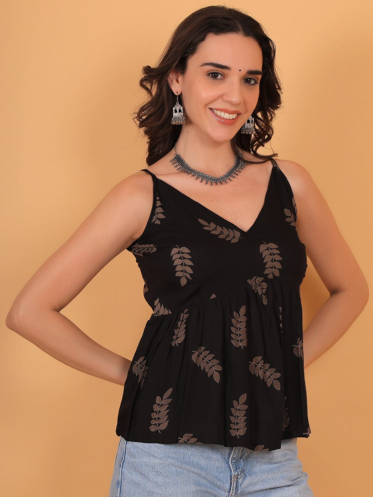 Female model demonstrating the relaxed fit and flared peplum structure of the ZUACC black and brown casual ethnic tunic.