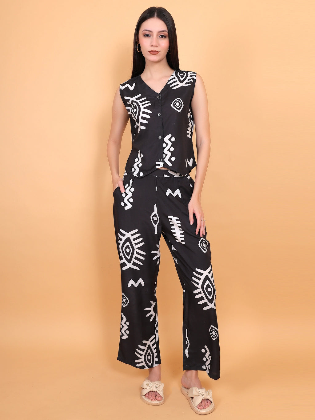 Trendy desk-to-dinner styling of a black tribal printed co-ord set paired with chic black block heels 
