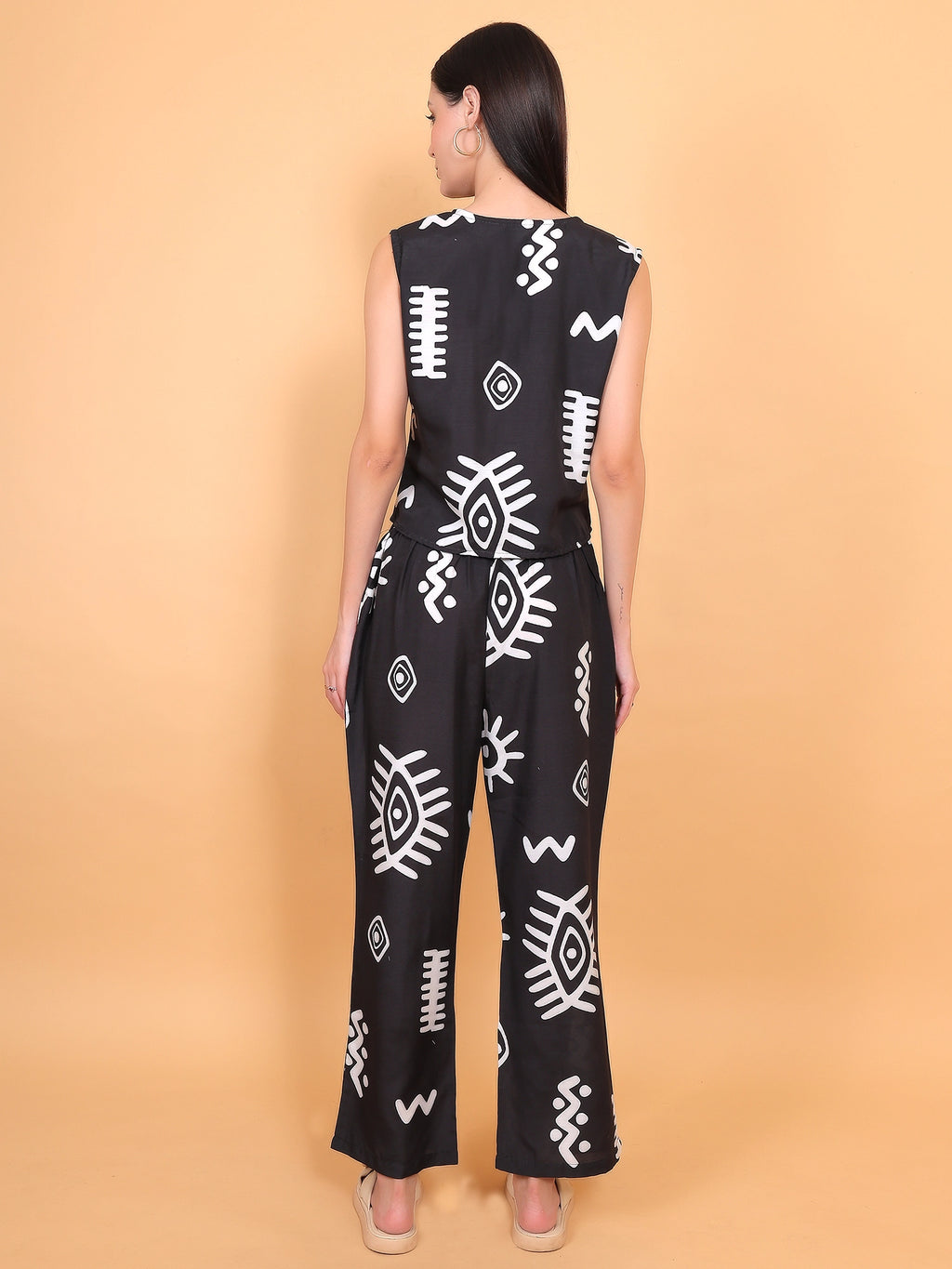 back full-length view of a regular-fit two-piece matching vest and pant set for women in a bold black and white tribal design.