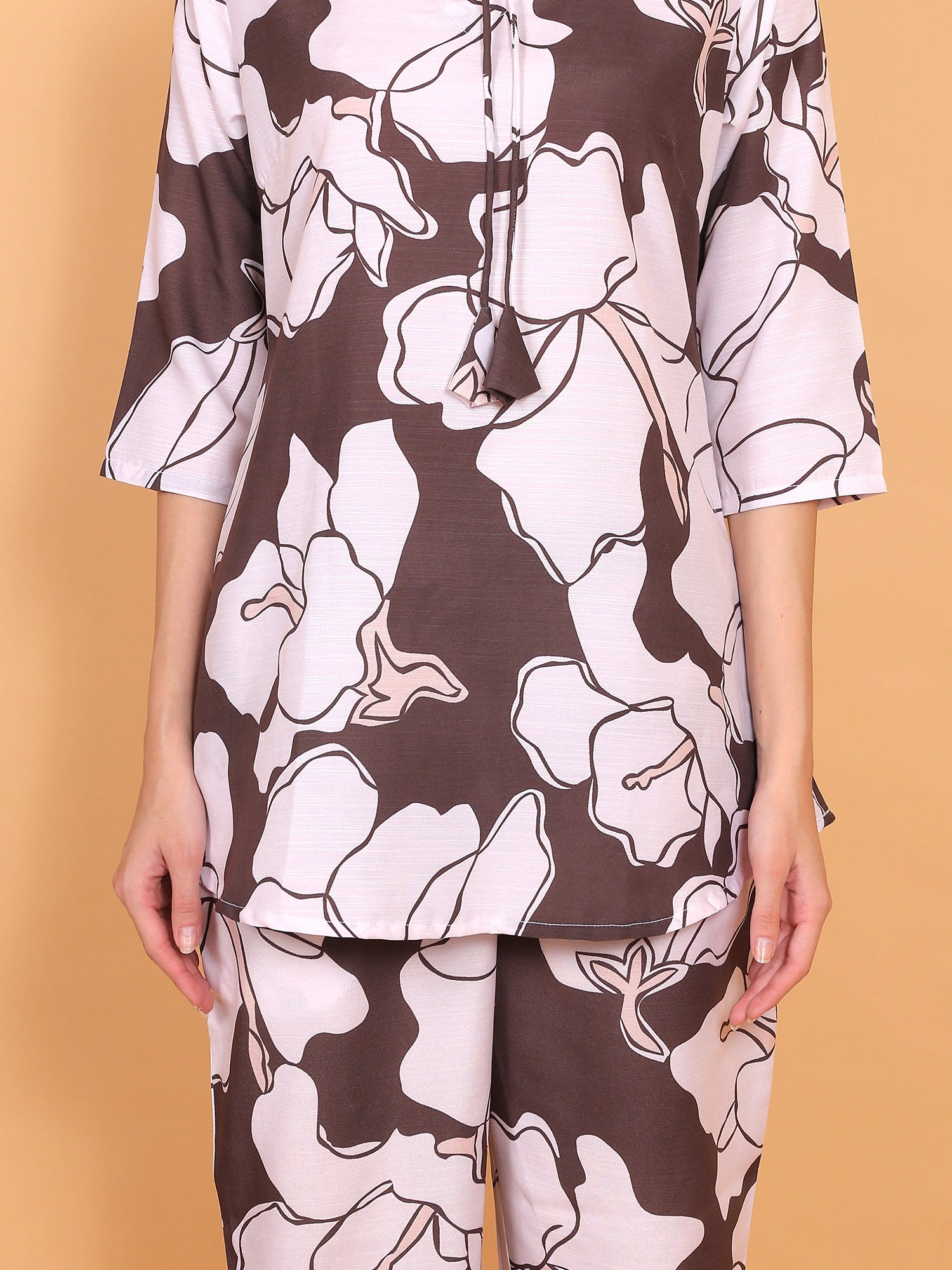 (Detail Focus): Close-up view of the two-piece polyrayon matching kurti and pant set showcasing the detailed brown and white floral design.
