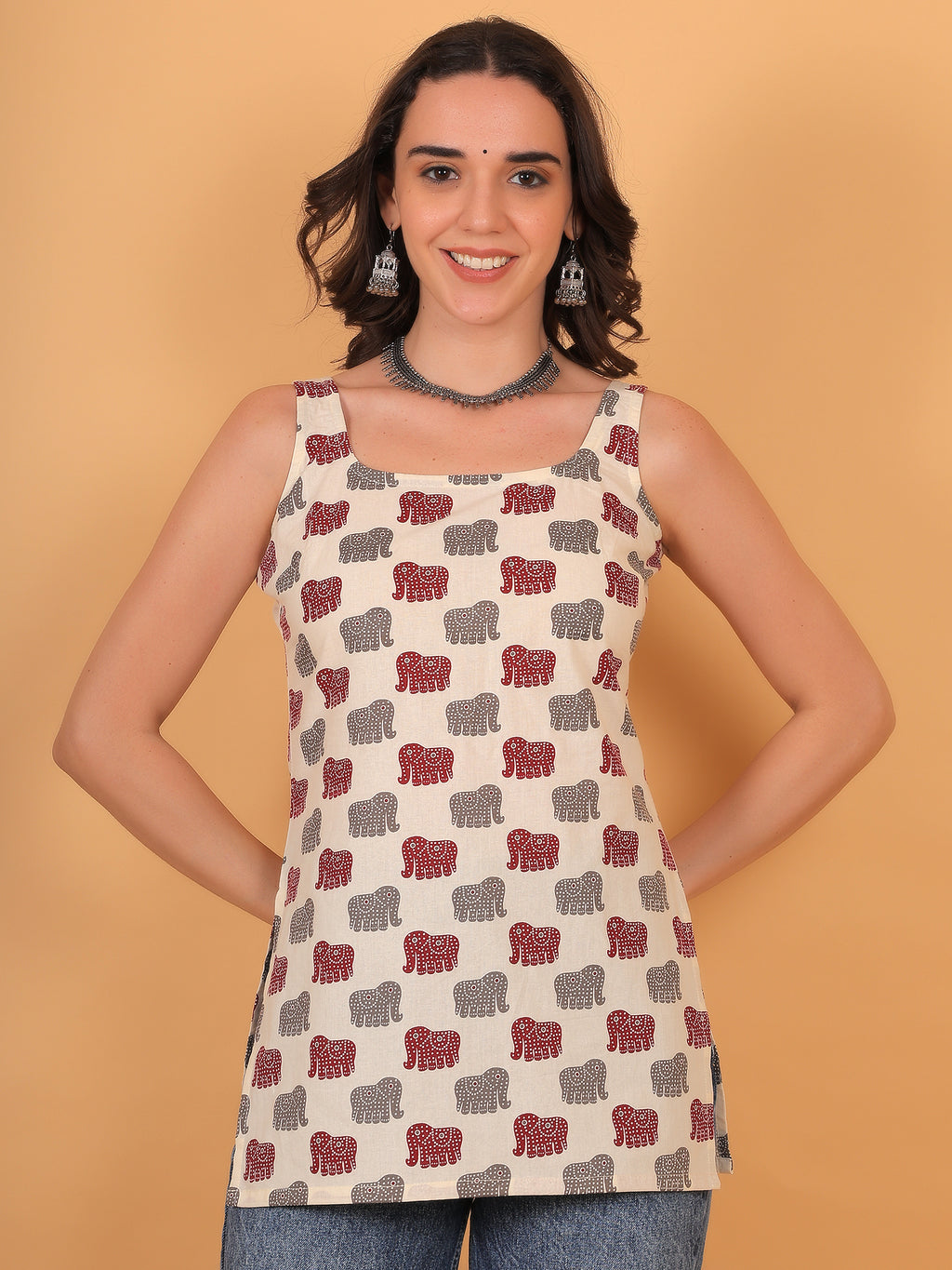 Model smiling in Airavat cream sleeveless kurti with traditional red and grey elephant print.