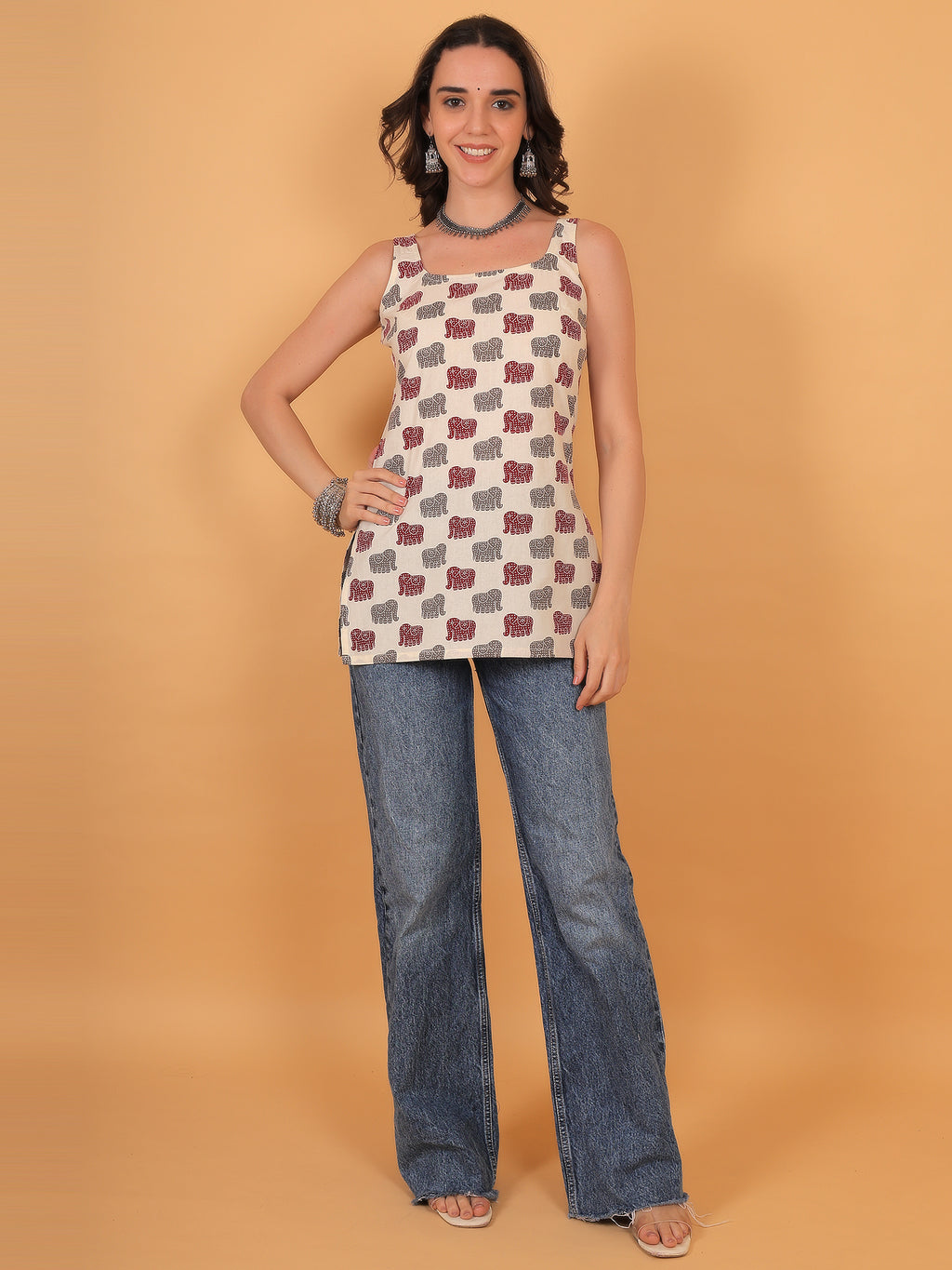 College outfit idea: Quirky elephant print kurti styled with silver necklace and denim.