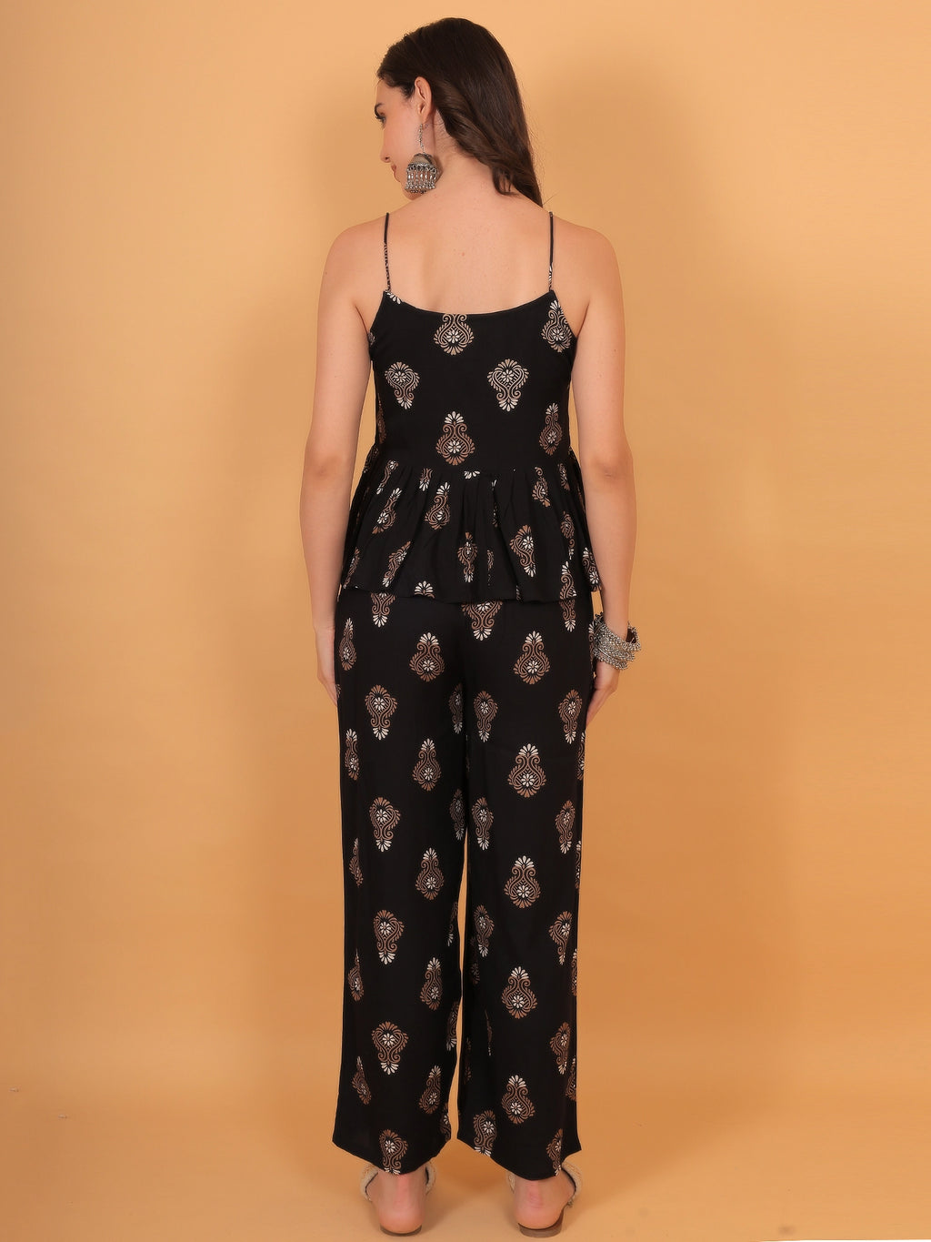 Back view styling of the strappy sleeveless peplum top from the black ethnic co ord set, offering a flattering regular fit.