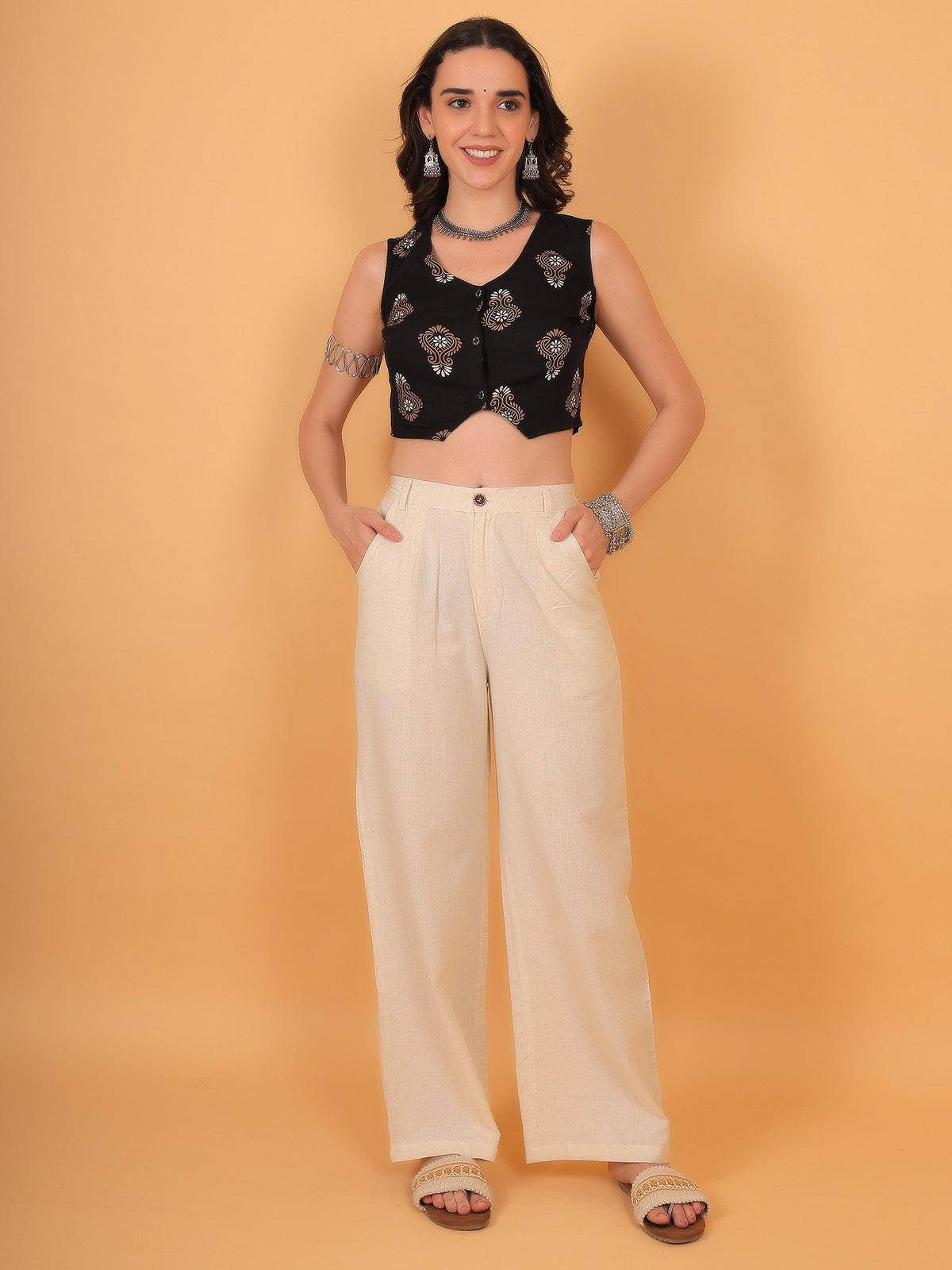 Flattering styling of an ethnic black crop top matching with contrast bottoms, creating a perfect look for festive wear or casual outings.