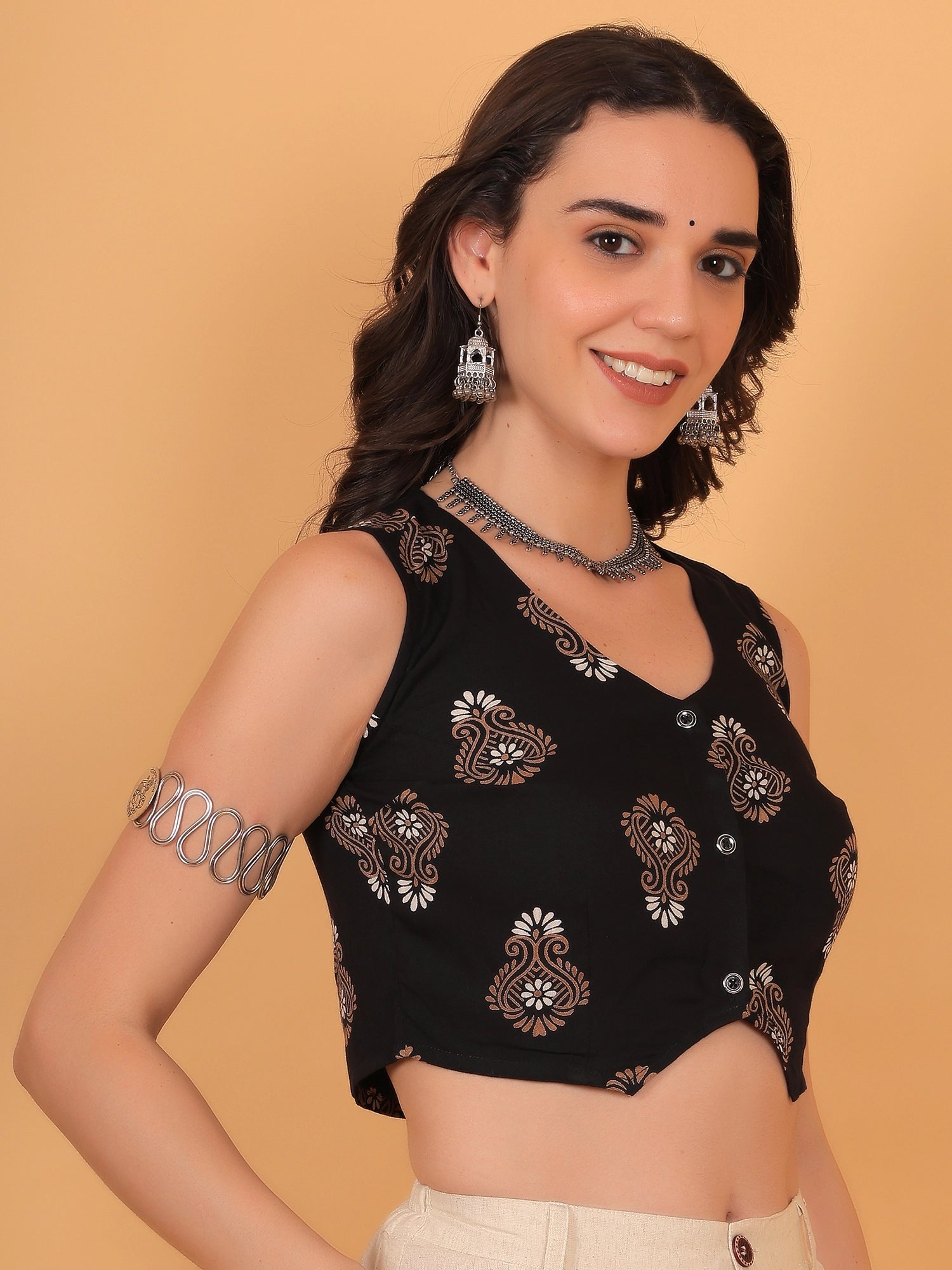 Side angle of a women black sleeveless vest top, offering trendy fit inspo for modern fusion styling.