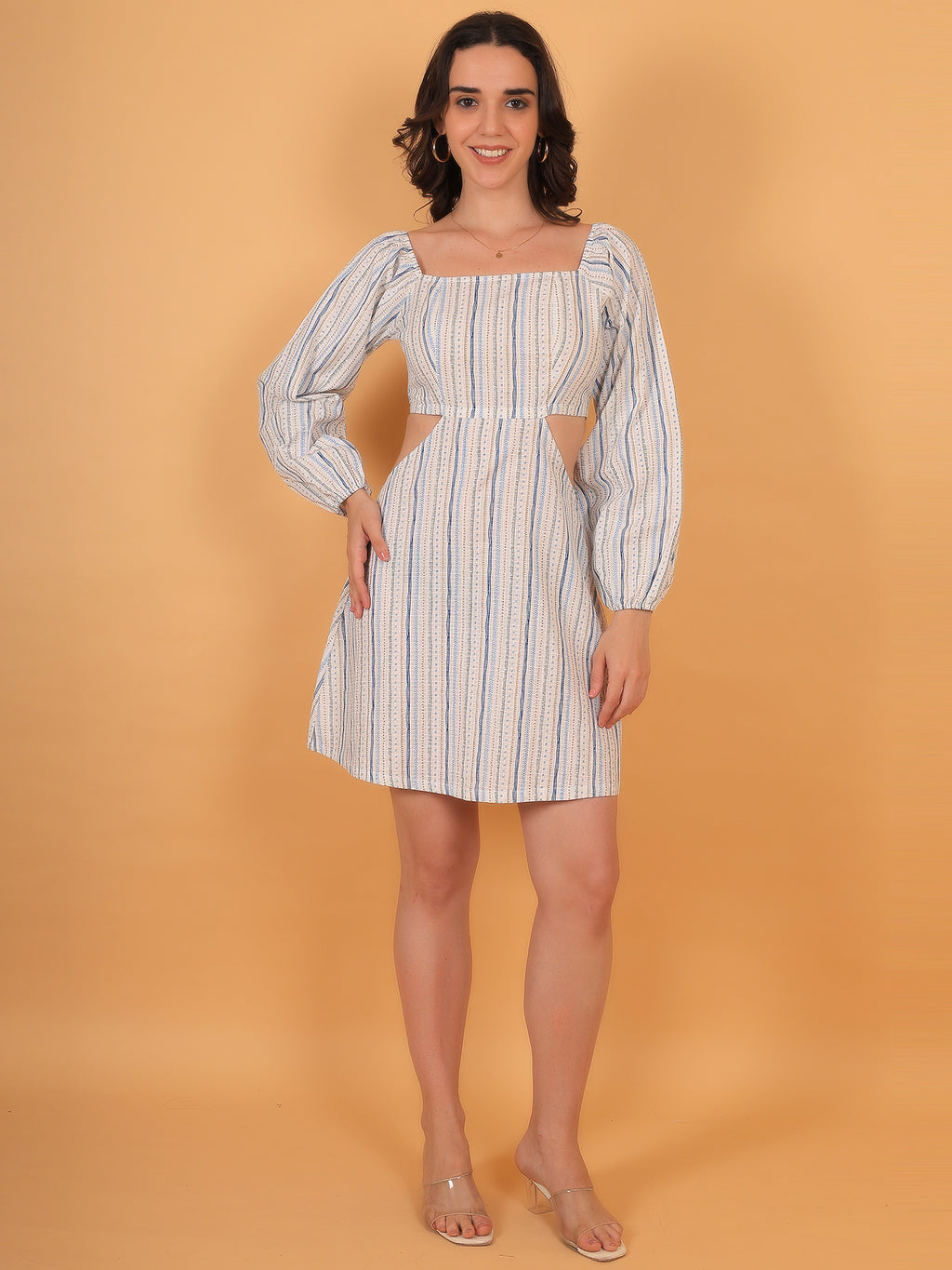 Model smiling in Breeze white mini dress with puff sleeves and waist cut-outs