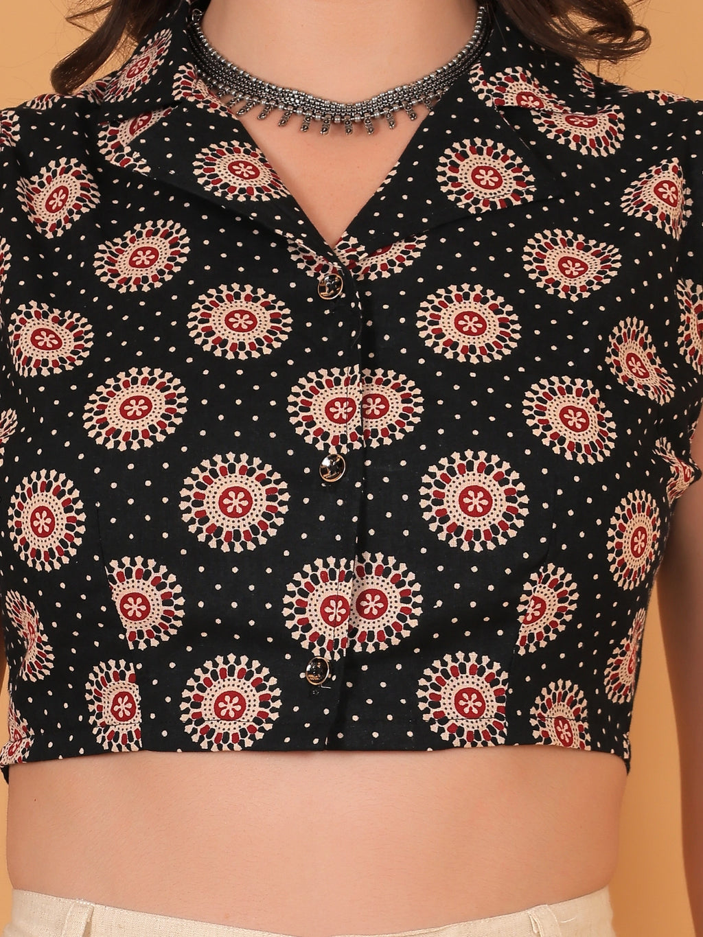Detailed close-up of the breathable rayon fabric, highlighting the crisp button closure and intricate traditional mandala motifs on the black ethnic crop shirt.