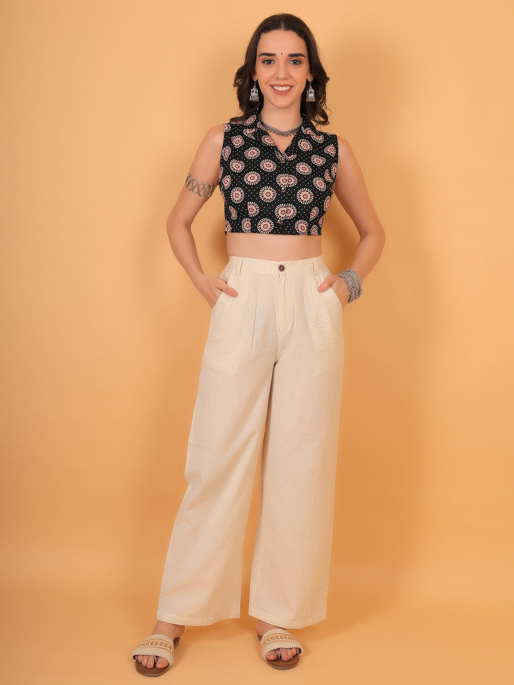 Woman wearing collared ethnic crop top paired with beige linen trousers.