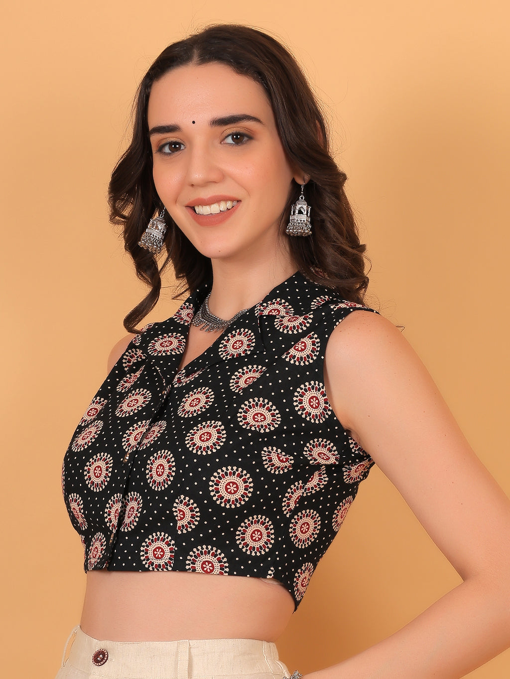 Close up of collar neck design and button details on black boho shirt.