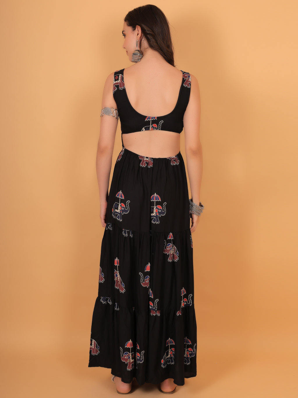 Back view of black vacation dress featuring trendy cutout and elastic fit for comfort