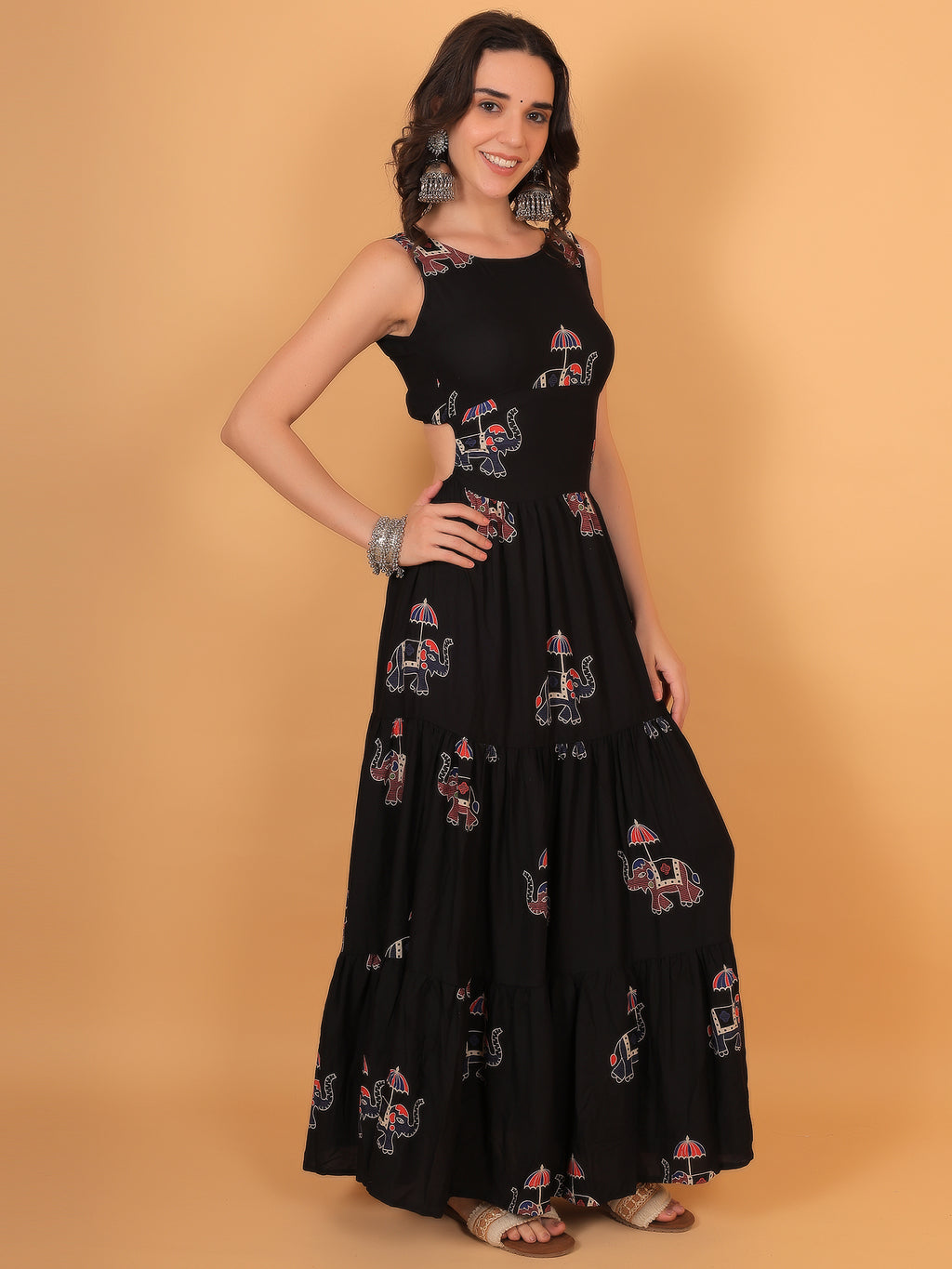 Close up of traditional elephant with umbrella motif on black cotton fabric.