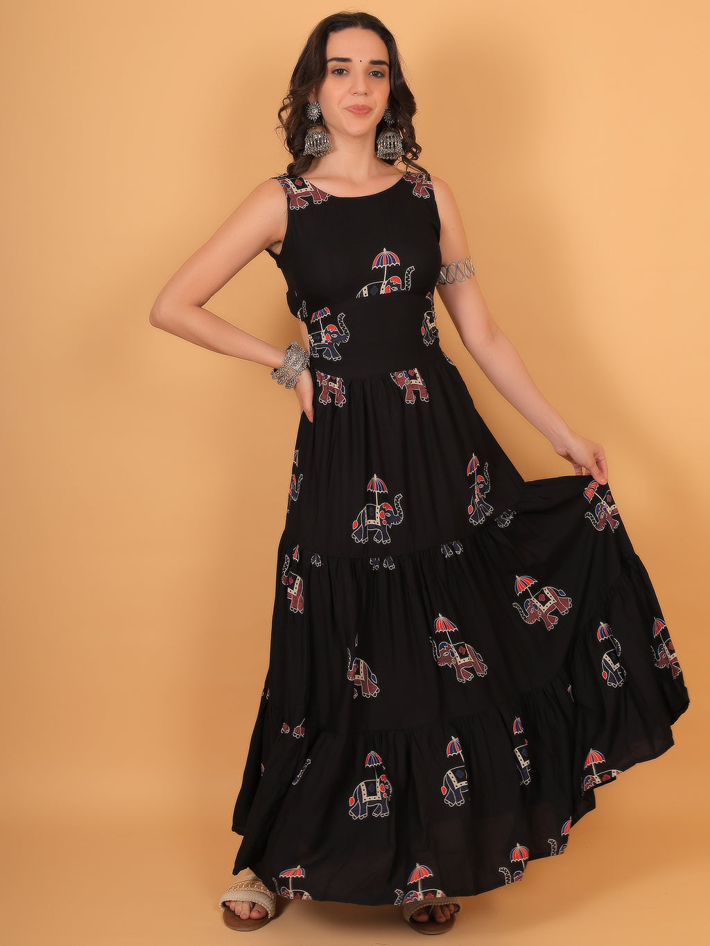 Vacation outfit idea: Black printed boho dress styled with silver jewelry and sandals.