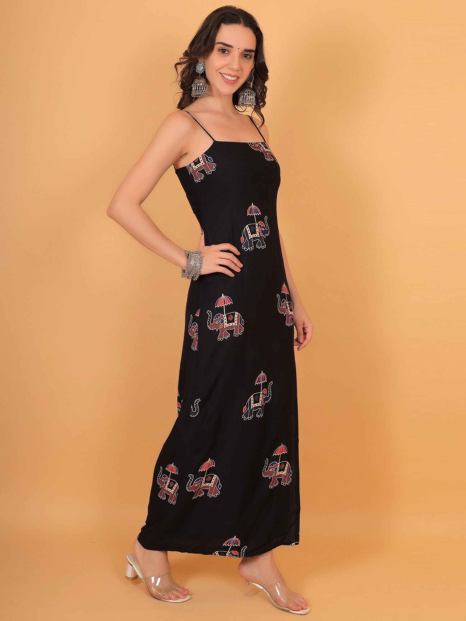 Side profile fit inspo of a women black ethnic dress showcasing the thigh-high side slit and flowy ankle-length drape.