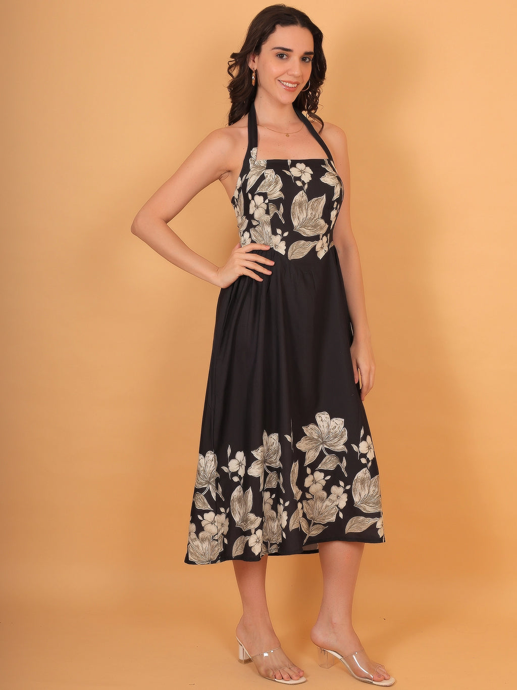 Full-length styling inspiration showing a women black floral print halter dress in a breathable fabric, a perfect choice for an elegant birthday dress.
