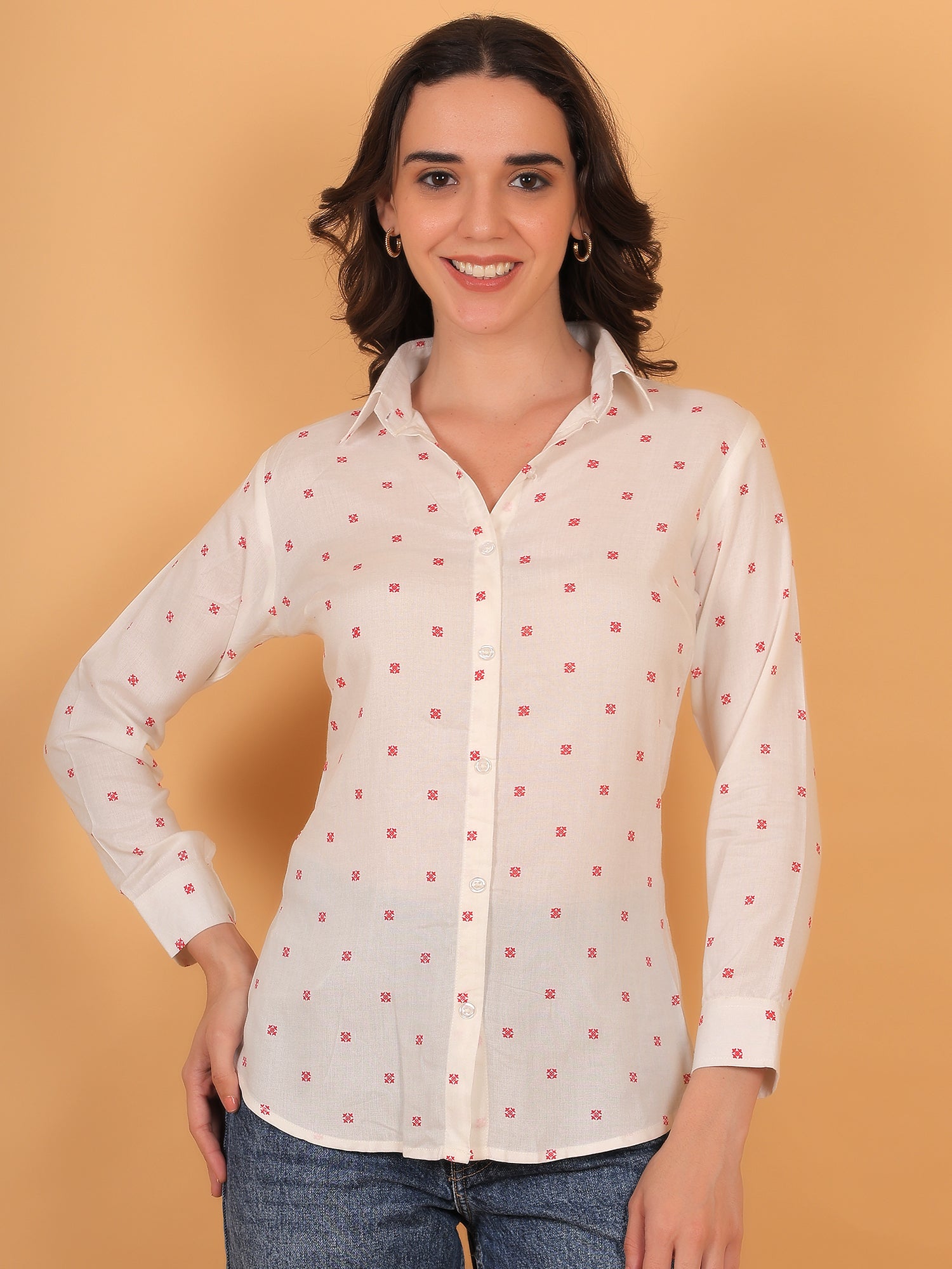 Model smiling in Prism white button-down shirt with small red geometric print.