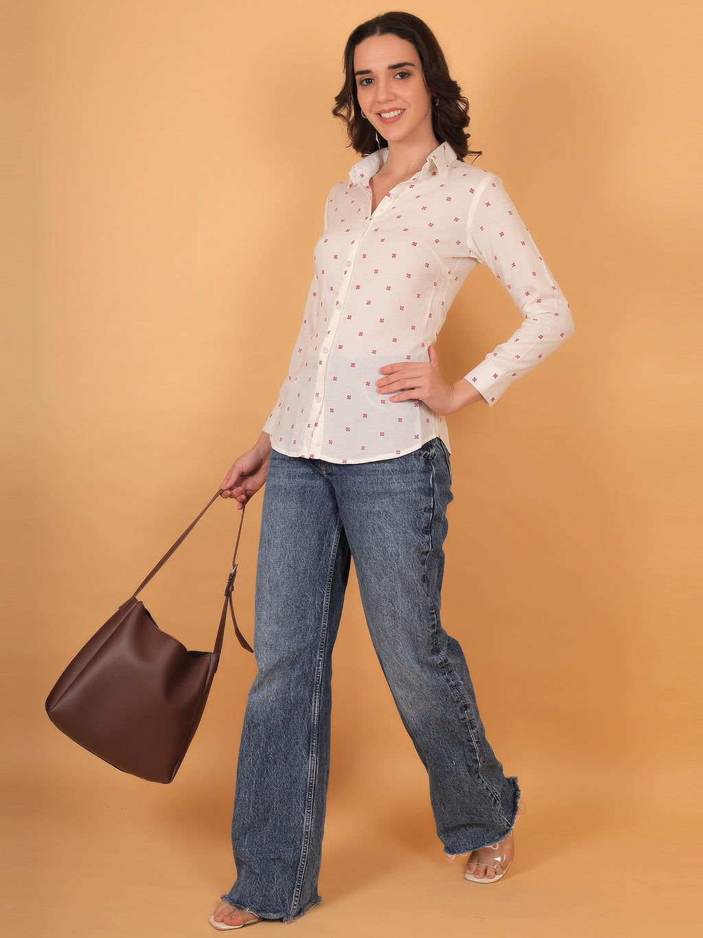 Full-length styling inspiration showing a women regular collar white shirt in a breathable fabric, paired with denim for a modern semi-formal look.