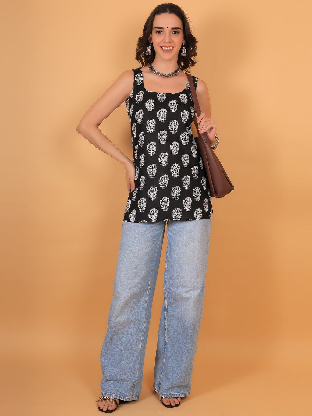 Smart casual office outfit idea featuring blue printed sleeveless tunic.