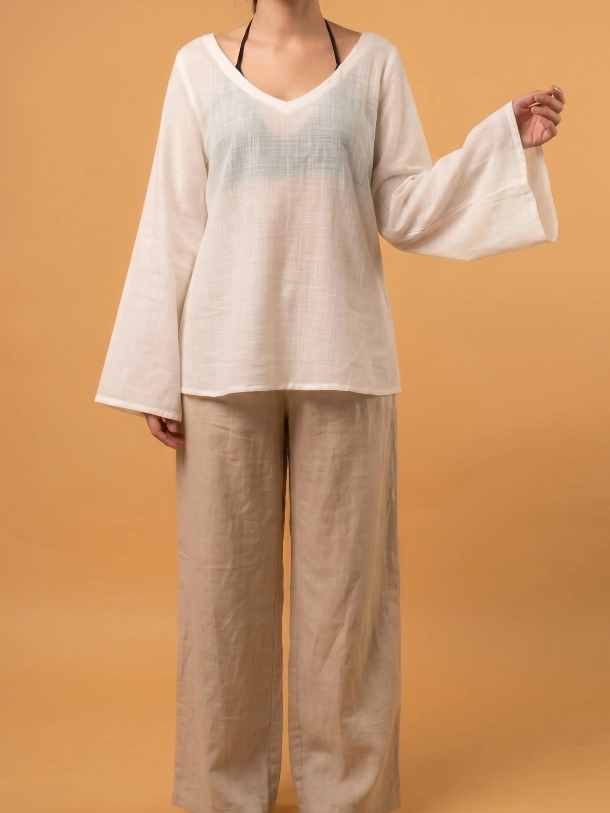 Comfortable loose-fitted sheer coverup shirt styled over a casual summer outfit for a modern western aesthetic.