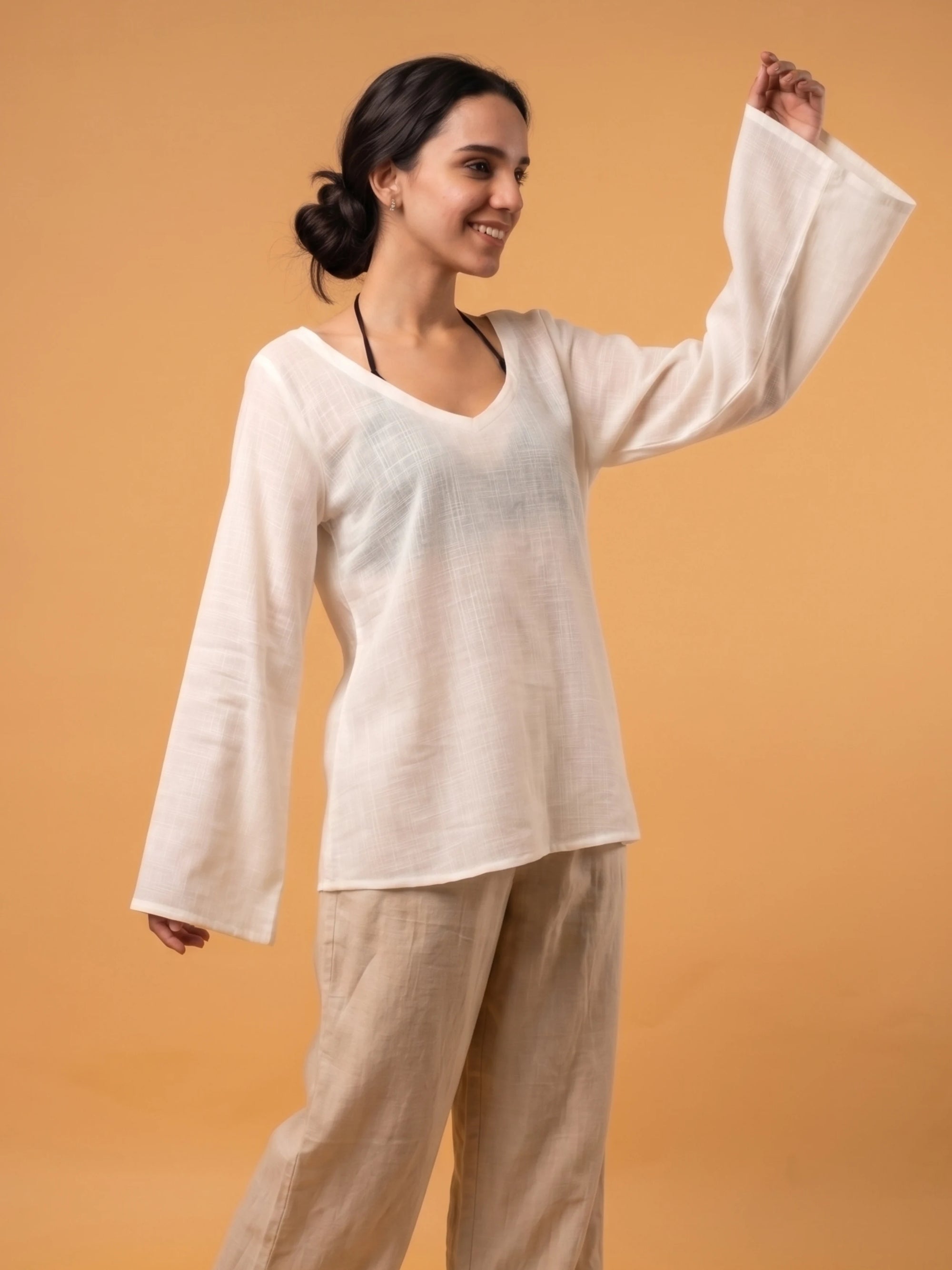 Flowy off-white sheer shirt worn as an elegant fusion cover up layer over ethnic desi clothing.